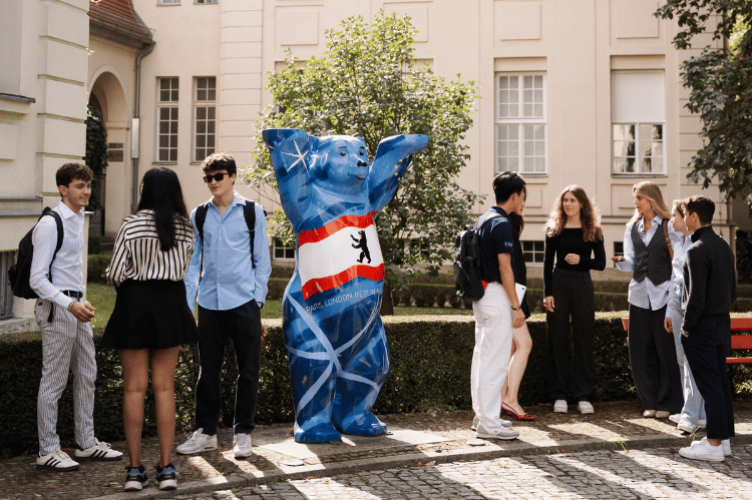 Students outside the Berlin Campus with a Berlin Bear